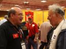 The Dayton Hamvention is the perfect place to catch up with old friends. Here, ARRL Membership and Volunteer Programs Assistant Manager Norm Fusaro, W3IZ (left), has an eyeball ragchew with a fellow Frankford Radio Club (FRC) member.  [S. Khrystyne Keane, K1SFA, Photo]