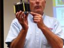 ARRL Education & Technology Program Director Mark Spencer, WA8SME, shows his class a cubesat. 