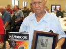 Victor Poor, W5SMM, holding the ARRL President’s Award and a hardbound copy of The ARRL Handbook signed by the ARRL staff. The award was presented July 9 at the monthly meeting of the Platinum Coast Amateur Radio Society. Poor passed away August 17. [Dan Fisher, AI4GK, Photo]