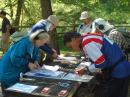 When you are given your orienteering map just before the competition starts, you may want to mount it on a flat surface for ease in marking bearings. Five competitors are getting ready for the 80 meter competition at the 2011 USA ARDF Championships: (left to right) Karla Leach, KC7BLA; Dale Hunt, WB6BYU; Matthew Robbins, AA9YH; Bill Smathers, KG6HXX, and Bob Frey, WA6EZV. [Joe Moell, K0OV, Photo]