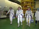 Garriott (left), along with Lonchakov (center) and Fincke, walk to the Soyuz TMA-13 capsule for their suited fit check at the integration facility of the Baikonur launch complex in Kazakhstan. According to NASA, the fit check was part of a busy agenda for the trio leading up to the October 12 launch aboard the Soyuz. [Victor Zelentsov, NASA, Photo] 