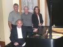 At the Chicago concert, August 2007: Standing left to right  Phil Amato, N9PA, former president, Chicago FM Club; Gerald Migely, WA9KXZ, and Kathryn Migely, KC9CKC and daughter of WA9KXZ. Seated at the piano, Martin Berkofsky, KC3RE. [Photo courtesy Gerald Migely, WA9KXZ]