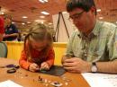 A father and daughter try their hand a kit building, part of the 2009 ARRL National Convention. [S. Khrystyne Keane, K1SFA, Photo]