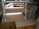 This is the rear right seat of the Tahoe.  Five pieces of plywood with 7 screws.  It also relies on a strap around the seat at the wood to keep the modular sections in place during bumps.  An area between the seats was also covered - to provide a wide area for writing, a pillow, whatever we wanted in the future.  This also provided additional strength/support to the overall structure.  