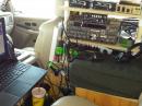 This picture shows pretty well the two operating positions and the equipment.  The far front right seat has the FT-847 and the right rear seat has the FT-736R.  The laptop fit well in that nylon structure, but it was really designed for a smaller device.  Still, it was better than being in your lap for a 1000 miles!  It did make the driver a little uncomfortable, because you had to sit more upright... but isn't that custom rectangular pillow awesome?  We had carefully set it up so that your right arm just reached easily to the FT-736R controls...  the switches could be adjusted by feel from any position in the car.