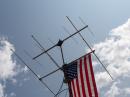 The flag hangs high from the 2m/6m antenna tower.
