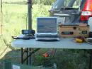 The station: IC-7000, logging computer, and wooden box containing Bioenno 15A-h LiFePO4 battery and solar controller. Three 15w panels kept the station on the air.
