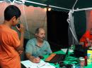 Visitor Luis Gomez of Strawn, Illinois gets on the air with K1DG in Maine with operator N9OQT with KC9YFL looking on.