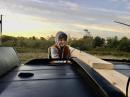 My son helps get the mast support secured to the roof rack on the minivan.