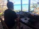 Rob K4OV operating C6ATF on the porch with a beautiful ocean view.