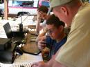 Bob Kassel, N2DMC, helps Life Scout Payton Kelly, KI4TLR, work HF