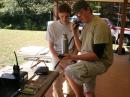 Troop 575's Scout Jonathon Cook works with Technician Class Douglas Brown, KJ4LTE, on 2 meters