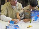 MINNEAPOLIS MN: A volunteer from North Star Museum of Scouting works with a Cub as he polishes a fine copper wire for part of the crystal radio the Cub made as part of the 2012 JOTA JOTI event hosted by North Star Museum of Scouting in North St Paul. Contact Info: N P Heille nrheill@mcg.net full story: http://tinyurl.com/nsc-jota-joti-google-doc
