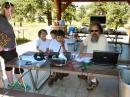Dan, NØBAF helping some visiting youngsters make their very first ham radio contact on the NØYE GOTA station.