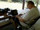 Club member Alan Travis (KR5T) tries his hand at digital communications during a quiet moment at Field Day 2010.