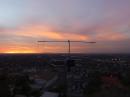 This photo was taken using a DJI Phantom 3 photographic drone quadcopter.  It shows the view from the Panorama Heights antennas looking across the L.A. Basin and out to sea at sunset.  If you look carefully, you can see antennas for 14 bands (7 MHz to 10 GHz).