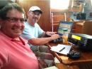 Tom (K4AEN) at the radio, and Rob (KK4R) logging in the cabin of Miss Adventure.