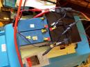 On the cool side of the window is the pair of 12v 12Ah batteries and the power end of the solar charger. The other two batteries shown would have been included in the circuit IF I could remember where the safe place was that I put all the other jumpers. The clamps from the charger also secured the leads for the TS-450.