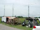 The setup at VE3WCC, with (left to right) operating trailer, 10 GHz station tent, and galley tent. Towers and antennas are in the background.
