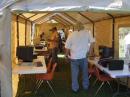 In the two tents that will house eight stations, Luke, KK7XX is setting up one of three radios loaned by AES for Field Day use.