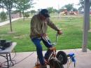 Neal, W5PVI, generating power for a PSK31 station.  The bicycle generator is a brainstorm and creation of Dan, WA8YYE.