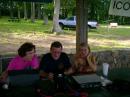 A teenager is recruited from the disc golf course to work the GOTA station.