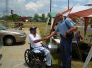NZ4T, Carroll County ARES EC, shaking the hand of State Patrol Officer KI4OFX