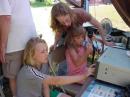 Laurie, KB3ORF, shows some young visitors the magic of the GOTA station.