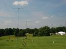 The "Lines".  Our 13 towers with yagis on top and wire antennas between are setup in two lines along a fairly unobstructed 1000 foot line with all antenna patterns "end to end".  Our operating tents are visible on the right. 