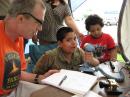 Phill Hogland, N0OE, assisting the children of Chanchal Roy, KD0CKZ.