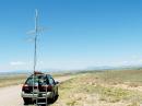 In DM74 southeast of Moriarty. The Sandias are to the left and the Ortiz mountains to the right in the background. Albuquerque is behind the Sandias.  The loop is at the top of the stack, then the 11 element 432 MHz WA5VJB Yagi, and then the 3 element 2M liaison antenna. The antennas are configured in the raised and stopped position.