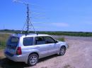 Looking south from EN44. The Radio Shack tripod is bolted to a Yakama roof rack.  Antennas from top to bottom are 2304 (40 watts), 3456 (40 watts), 432 (100 watts), 222 (120 watts), 1296 (50 watts), and 902 (25 watts).