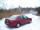 In this photo that was taken on Sunday, you can see the three-element Two Meter Yagi that is mounted on a tripod on top of the car roof and the three-element Six Meter Yagi that is inserted into an umbrella stand that is located in front of the car.  Note the large snow flakes that was coming down at the time!