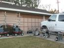 Here are eight 10-band VHF+ stations in one place.  At left are the original two rover stations, stored between contests on red "Radio Flyer" wagons (of course).  At right there are four "toolbox" stations, each containing transverters (and in some cases, amplifiers) for all bands 902-10368 MHz, all housed in a 20" Craftsman toolbox.  They can be mounted on roof platforms with rotors or placed in a truck bed for use.  Each has a console with VHF+ transceivers, a rotor control and the remote control unit for the toolbox.  The console is typically placed on the passenger seat for one-person operations.  At right, a Ford E350 van and F150 truck (whose antennas are barely visible) house two more 10-band stations.  Altogether, there are 54 transverters and 24 transceivers in the eight stations, with a number of amplifiers ranging in power from a few watts on 10 GHz to full kilowatts on six and two meters.  