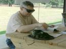 Dan Beavers (KE5WJN), takes a break during the Field Day event to brush up on information in the ARRL Handbook from the Information Table operated by the Pearl River County Amateur Radio Club Field Day 2009 event.  Photo by Larry Wagoner (N5WLW).