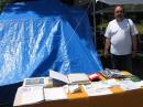 Tedd KB8NW NODXA Club President manning the Public Information Table.  Not much wind this year to blow things around!