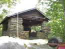 Here's the stone &amp; log shelter I operated from. Notice my wheelbarrow taking a rest from its transportation duties. 