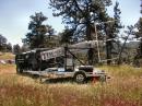 The excellent 50-foot home-brew portable tower trailer assembly is brought into position by tower owner and constructor Allen Bishop's, KØARK H2 Hummer. 