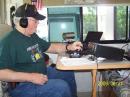 Bob Davis operating the CW station.  Note the cantenna on the far side providing the computer link over about 400 foot.  
