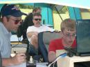 Chris Markovich, KC9OHM, age 16, makes another GOTA contact while his father, Joe, KB9OI proudly looks on.  GOTA coaches, Kerry Orze, KB9ORH, and Bill Johnson, KC9MTP are in the background.