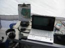 Essential operating gear for remote mountain site: FT-100D, headphones, grid map, laptop for logging and ... oh yeah, a Glock .40 S&amp;W.