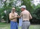 The June summer heat in Texas as you know can be "extreme". KM5XB (Steve) with his new "cool" Field Day haircut offers KD5DXZ (Irwin) a trim. -- N5HT

