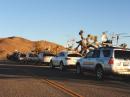 Seven rover stations line up for a photo opportunity in Joshua Tree National Park, with the bizarre shapes of the 
trees competing with toolbox stations for visual drama.  This photo was taken in the rare grid of DM23 just before the end of the contest.  N6VI's 4Runner is in the foreground at right.