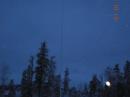 A picture of the antenna, tuner and radial system out in the snow.  My cabin is in the background.