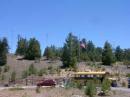 Field Day site, Our comm bus and 3 towers on hill, 2 CW 1 SSB and the VHF mast/ flagpole on the bus