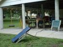 Our solar charger and battery.  NØNB at the controls while KØBYK looks on.
