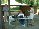 Rich KC2HZW telling a local reporter about ham radio.  Gabe KB2MAR looks like he wants to say something to her (just dont't know if its about radio)