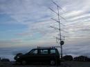 The shack and antennas floating atop the undercast...
