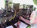 Dave Benson, K1SWL, operates one of HQ-Coy's three, 1943-original, Wireless Sets No. 19.  The vibrator and dynamotor power-supply in the module at far left drew 4 A (receiving) to 10 A (transmitting, CW, key down) at 12 VDC from storage batteries under the table.  An original WW II gasoline-powered generator recharged these batteries.  The 19 Set transmits 10 W on CW and its receiver bandwidth is 9 kHz -- so copy was difficult under the crowded Field-Day band conditions.  Nevertheless, confirmed FD exchanges were completed with 60 stations on 40 and 80 meters.