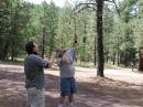 NA7D and WM7A use the classic slingshot method to install a dipole antenna in the tall pines.